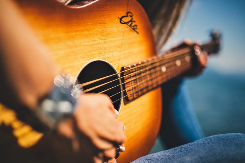 guitar player playing easy country songs on guitar