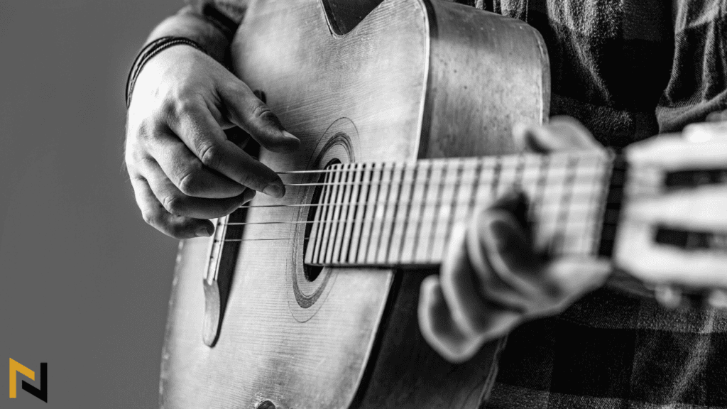 Displays old acoustic guitar