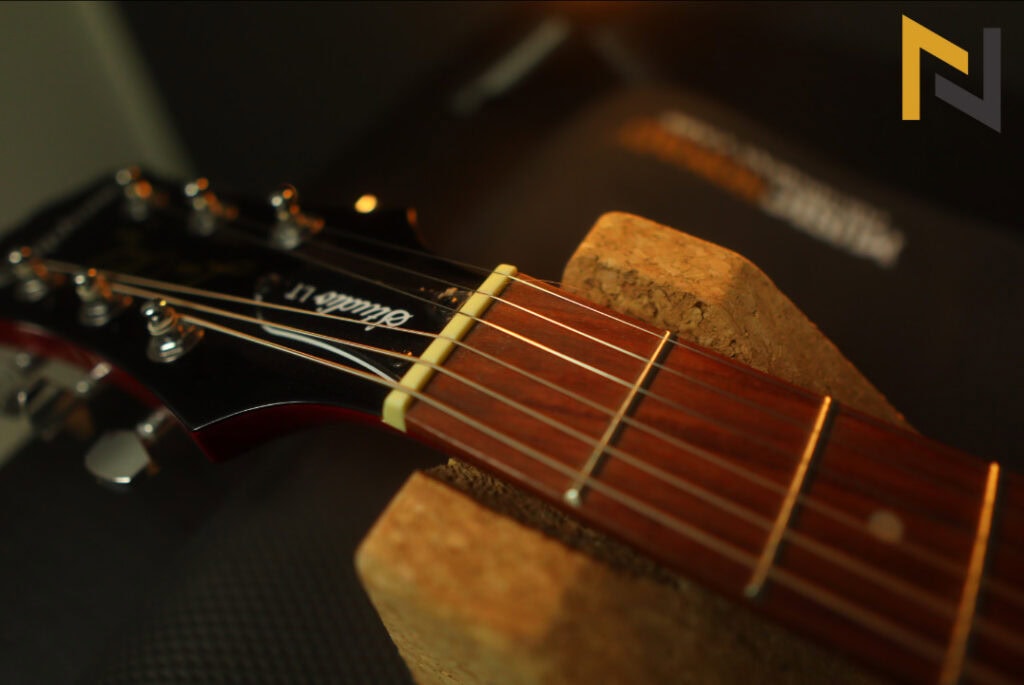 Displays Epiphone Les Paul Studio E1 electric guitars nut and headstock